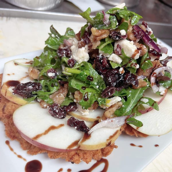 Bazzarelli's chicken cutlet topped with arugula, cranberries, walnuts, feta, and pear slices.